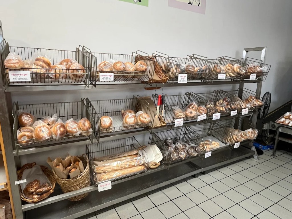 Metal shelving stacked with bagels in baskets